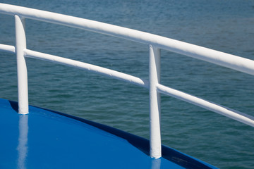 Fototapeta na wymiar Seascape from boat with boat part railing blue and white