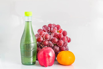 Juice and fruit on background.