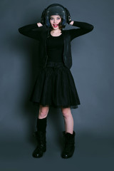 girl with dark short hair wears biker clothes. leather jacket and helmet