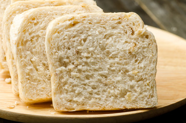 Close up of whole wheat bread on wooden plate