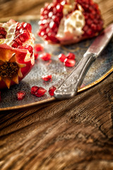 Pomegranate on rustic table