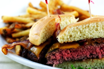 Traditional Bacon Cheeseburger prepared medium rare served with golden fries.