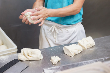 Preparing pizza dough in pizzeria