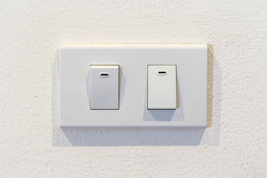 Light switch on white wall