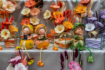 Pumpkin fairy with autumn flowers on the background