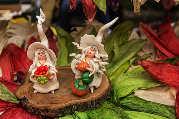Pumpkin fairy with autumn flowers on the background