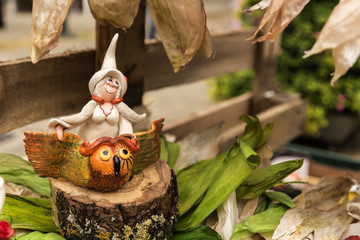 Pumpkin fairy with autumn flowers on the background
