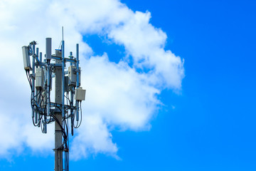 Telecommunication tower with the blue sky and some cloud.