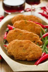 cod fish croquettes on dish  with red wine