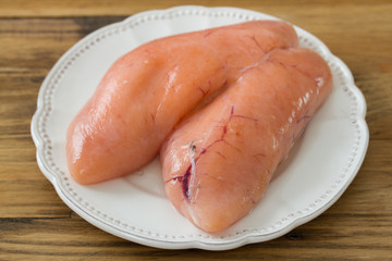 eggs of fish on white plate on brown background
