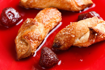 Homemade cookies with strawberry jam on a red plate