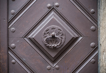 Iron knocker on the old wooden door