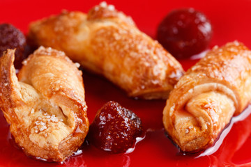 Homemade cookies with strawberry jam on a red plate