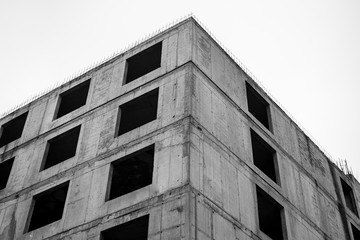 Old unfinished concrete building. Black and white photo.