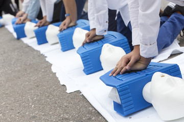 man instructor showing CPR on training doll