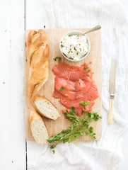 Salmon, ricotta and fresh parsley with baguette on a rustic