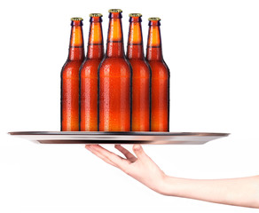Waitress holding tray with bottles of beer isolated