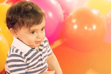 Fototapeta na wymiar portrait of happy baby boy with yellow ballons