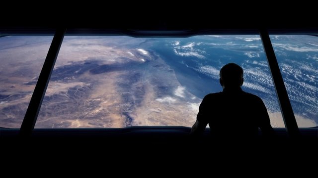 Astronaut Looks Out At Earth From Orbit