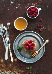 Breakfast set. Buckwheat pancakes with fresh raspberries, honey