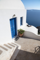 Santorini - house wiht the white stairs and blue doors in Oia.