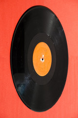 Black vinyl record isolated on colored background