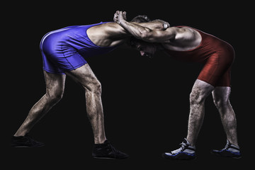 Two wrestlers holding each other in stand isolated
