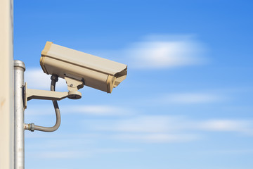 CCTV camera on pole with blue sky clouds in background. Security equipment and system technology for installation at outdoor for monitoring, privacy control, safety and protection home house building.