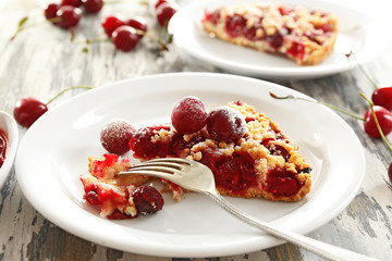 Tasty homemade pie with cherries on table close up