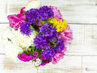 bouquet of colorful flowers on white wooden planks