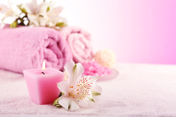 Spa treatment and flowers on wooden table, on light background