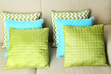 Colorful pillows on sofa, close-up