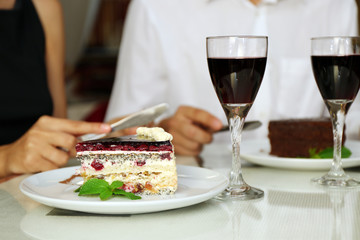 piece of chocolate cake and wine glass