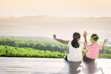 Fototapeta premium Sister and brother watching views at sunset
