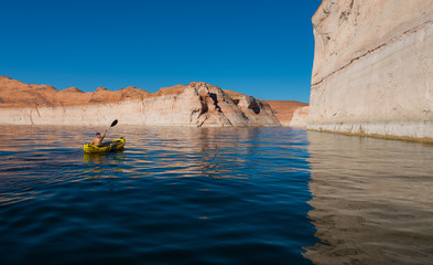 Naklejka premium kayaker paddling the calm waters of Lake Powell Utah
