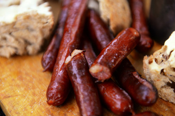 Grilled sausages on cutting board in the wood