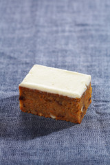 carrot cake and cream cheese on blue fabric