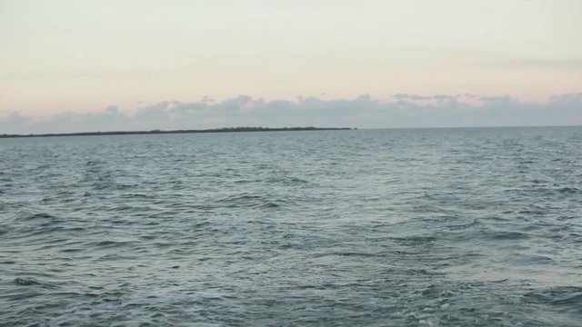 Shot from back of yacht cruising at dusk