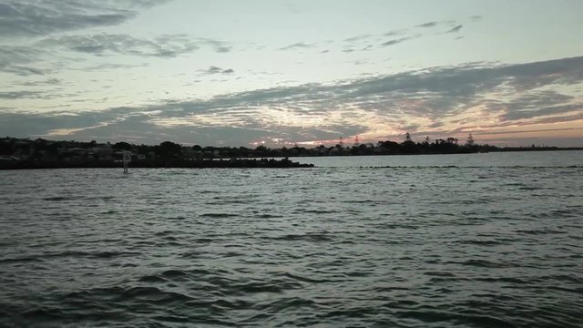 Shot from back of yacht cruising at dusk