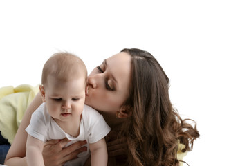 Loving mother kissing her adorable little child