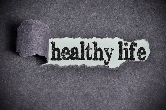 healthy life word under torn black sugar paper