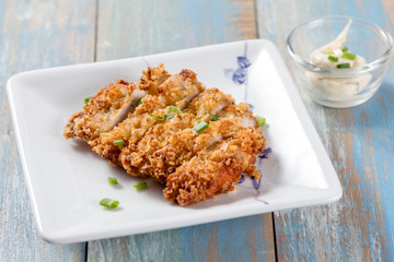 Japanese fried pork name is tonkatsu in white dish