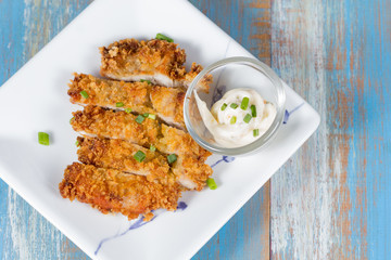 Japanese fried pork name is tonkatsu in white dish