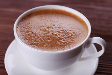 Cup of coffee on wooden background
