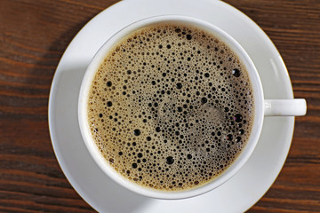 Cup of coffee on wooden background