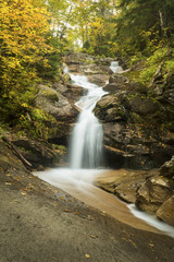 Cascade of Swiftwater Falls over granite rocks, Franconia, New Hampshire.