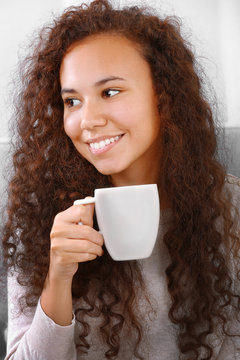 Close up portrait of pretty young women drinking coffee on white background
