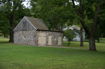 Obraz premium Stone Barn among the Trees