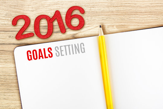 2016 Goals Setting word on notebook lay on wood table,Template m
