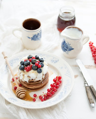 Breakfast set. Buckwheat pancakes with fresh berries, honey